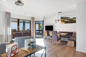 a living room with a couch and a dining room at Ferienwohnung Niki in Titisee-Neustadt