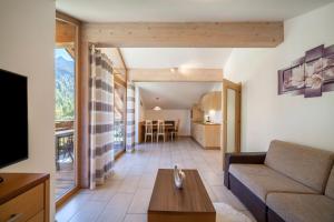 a living room with a couch and a table at Ferienwohnung Edelweiss in Pfelders