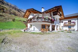 a house with flowers on the balconies of it at Ferienwohnung Edelweiss in Pfelders