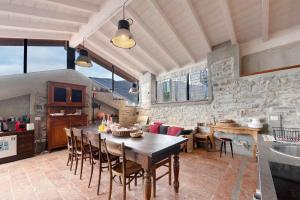 a kitchen and dining room with a table and chairs at Loft e Veranda sul Lago di Como in Blevio