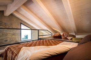 a bedroom with a large bed in a house at Loft e Veranda sul Lago di Como in Blevio