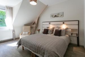 a bedroom with a large bed and a staircase at L'Instant Nouveau chambres d'hôtes in Carennac