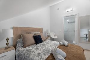 a bedroom with a large bed and a bathroom at Villa Atlantico in Candelaria