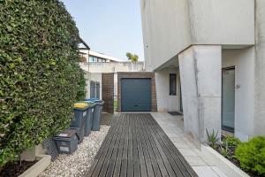 a hallway of a house with a blue garage at Annex Bedroom - Oporto Garden in Porto