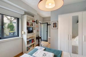a living room with a couch and a window at Annex Bedroom - Oporto Garden in Porto