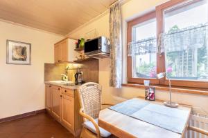 a small kitchen with a table and a window at Haus Rosi und Werner in Emmerting