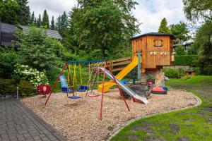 a playground with a slide and a play house at Haus Schönblick in Willingen