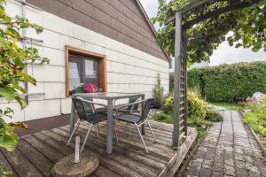 a table and two chairs on a wooden deck at Haus Rosi und Werner in Emmerting