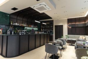 a bar in a restaurant with tables and chairs at Hotel Erika in Alexandroupoli