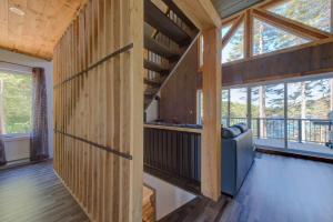 a room with wood paneling and a couch in a house at Luft Skift Spa - Waterfront & Private Spa in Lac-aux-Sables +31 photos