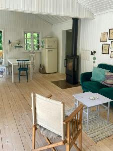a living room with a couch and a table at Holiday Home By Nyrup Bay And Rørvig Harbour in Rørvig
