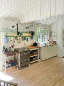 a kitchen with white walls and a wooden floor at Holiday Home By Nyrup Bay And Rørvig Harbour in Rørvig