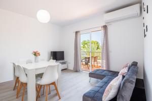 a living room with a couch and a table at Gran Sol Family 8 in Felanitx