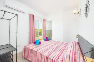 a bedroom with a bed with a dresser and a tv at Gran Sol Family 8 in Felanitx +21 photos