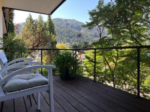 a balcony with two chairs and a view of the mountains at Sonnige Ferienwohnung im Kinzigtal in Wolfach