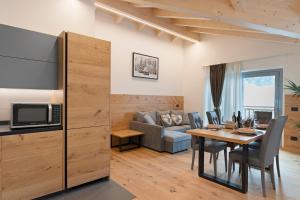 a living room with a table and a couch at Alpen Blumen in San Lorenzo in Banale