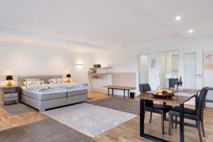a bedroom with a bed and a table and a dining room at Sonnige Ferienwohnung im Kinzigtal in Wolfach