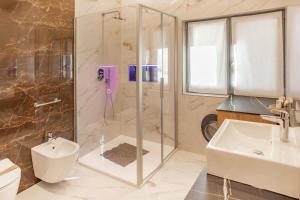 a bathroom with a shower and a sink and a toilet at Alpen Blumen in San Lorenzo in Banale +74 photos
