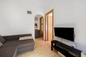 a living room with a couch and a flat screen tv at Casa Vitorino in Sagres