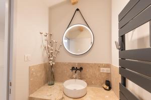 a bathroom with a sink and a mirror at Villa chardonnay in Pradons +12 photos