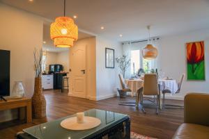 a living room with a table and a dining room at Second Home in Birlenbach