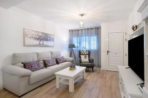 a living room with a couch and a table at Casa Reguemar in Arrecife