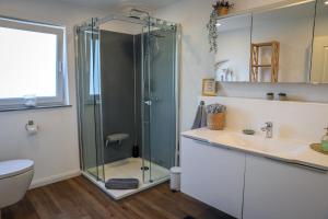 a bathroom with a glass shower and a sink at Second Home in Birlenbach +34 photos