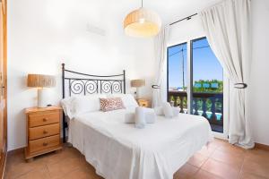 a bedroom with a bed and a large window at Villa Petre in Cala en Porter +25 photos