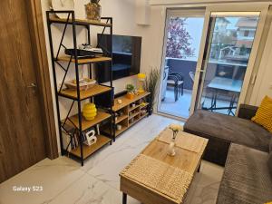 a living room with a couch and a table at Blue Wave in Paralia Katerinis