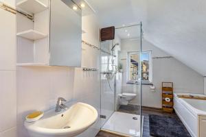 a bathroom with a shower and a sink and a toilet at Ferienhaus Glücksschmiede in Schmallenberg +17 photos