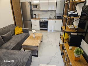a living room with a couch and a table at Blue Wave in Paralia Katerinis