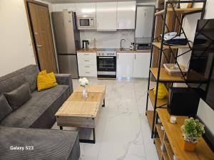 a living room with a couch and a table at Blue Wave in Paralia Katerinis