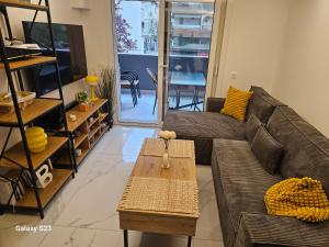 a living room with a couch and a coffee table at Blue Wave in Paralia Katerinis +8 photos