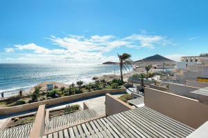 a view of the beach from the balcony of a condo at Casa Médano 17 in Granadilla de Abona