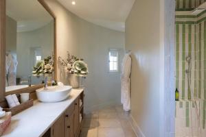 a bathroom with a sink and a shower at La Bastide d'Antoine in Saint-Tropez