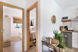 a kitchen with white walls and a door leading into a room at Villa Tino- Casa M in Los Llanos de Aridane