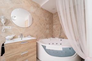 a bathroom with a tub and a sink and a mirror at Hosteria Las Fuentes in Rubayo +101 photos