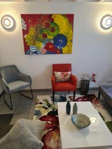 a living room with two chairs and a table at Das Moevennest in Bad Camberg +18 photos
