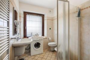 a bathroom with a sink and a washing machine at Verger Plein Soleil di Piero in Saint-Pierre +64 photos