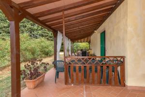 a porch with a wooden pergola at Il Nazareno - Civetta in Cecina