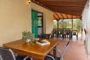 a dining room with a wooden table and chairs at Il Nazareno - Civetta in Cecina