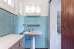 a bathroom with a sink and blue tiles at Chez Lina - studio avec terrasse in Le Lavandou +14 photos