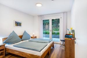 a bedroom with a bed and a large window at Ferienwohnung Vogesenpanorama in Bad Bellingen