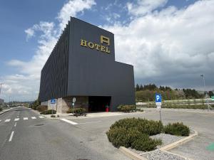 a hotel building with a sign on the side of it at Hotel A plus in Celje