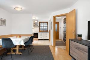 a kitchen and dining room with a table and chairs at Apartment Weber in Nova Levante