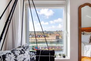a room with a window with a view of a field at Salina Ria Studio in Aveiro