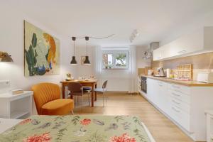 a kitchen with a table and a dining room at Casa Limone in Ammerbuch