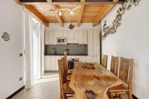 a dining room with a wooden table and chairs at Villa Lice - Vigneto in Casarza Ligure