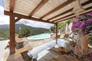 a patio with a swimming pool and a wooden pergola at Villa Lice - Vigneto in Casarza Ligure