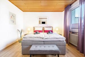a bedroom with a large bed with two teddy bears on it at Fewo Mama Mia in Menden